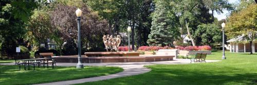 a park with a fountain and benches and a statue at Fully Furnished 2 Bed / 1 Bath - Downtown Appleton in Appleton