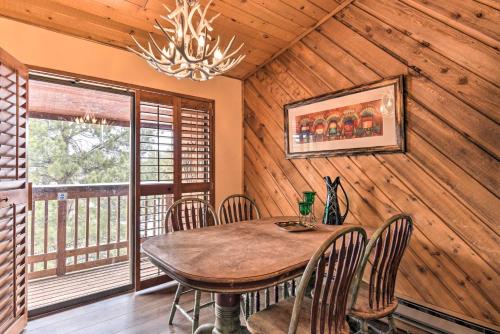 a dining room with a table and chairs and a chandelier at Lovely New Mexico Retreat with 4 Private Balconies! in Angel Fire