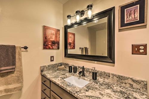 a bathroom with a sink and a mirror at Lovely New Mexico Retreat with 4 Private Balconies! in Angel Fire