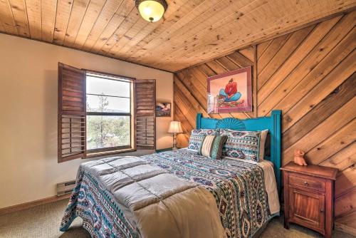 a bedroom with a bed and a wooden ceiling at Lovely New Mexico Retreat with 4 Private Balconies! in Angel Fire