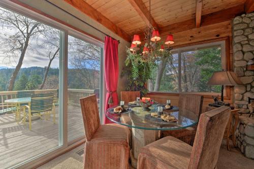 a dining room with a table and chairs on a deck at Mountainside Cabin with Deck - 16 Miles to Skiing! in Lake Arrowhead