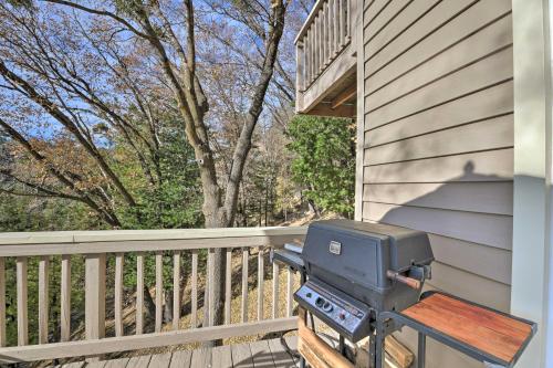 a grill sitting on the porch of a house at Mountainside Cabin with Deck - 16 Miles to Skiing! in Lake Arrowhead