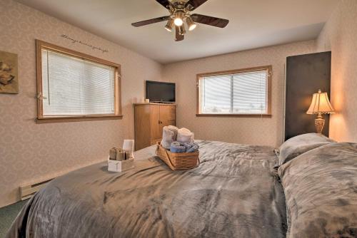 a bedroom with a large bed with a ceiling fan at Private Hot Tub and Fireplace Poconos Home! in Pleasant Mount