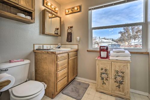 a bathroom with a toilet and a sink and a window at The Diamond Bungalow - Cozy Caldwell Home! in Caldwell
