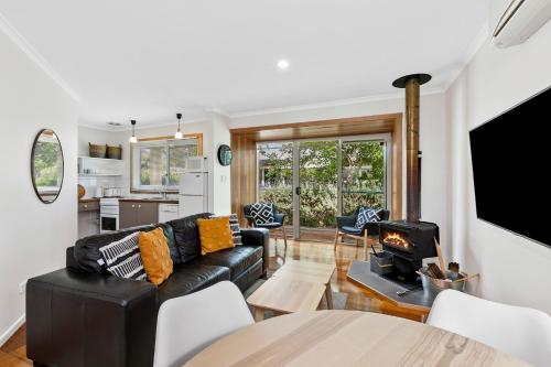 a living room with a couch and a fireplace at Seahaven Village in Barwon Heads