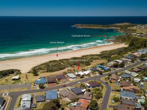 an aerial view of a beach with houses and the ocean at Panorama Place on Jones Beach in Minnamurra