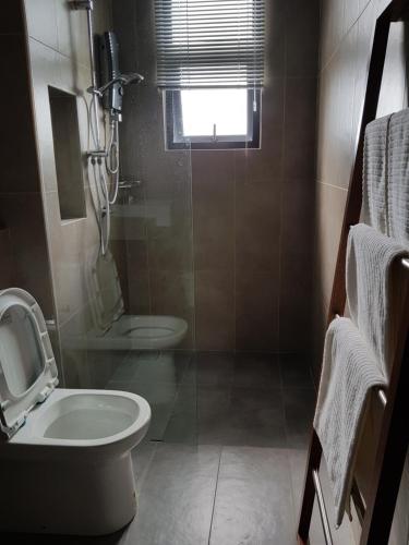 a bathroom with a toilet and a sink at Timurbay studio apartment facing beautiful beach in Kuantan