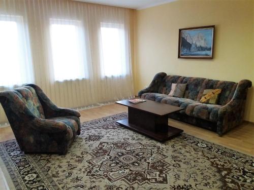 a living room with two couches and a coffee table at Отель центр Трускавца in Truskavets