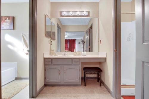 a bathroom with a sink and a mirror at Sweet Home Georgia - Entire 3 bedroom Luxury in Duluth