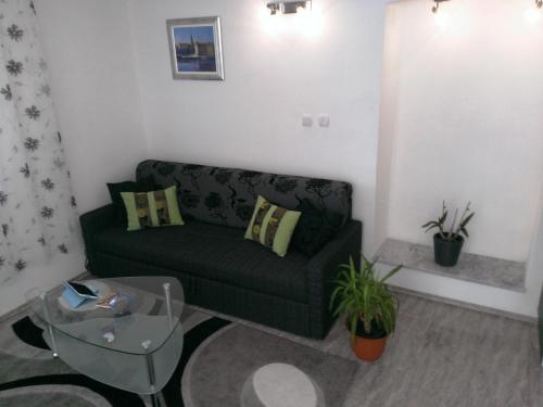 a living room with a green couch and a table at Apartments Jasminka in Solin