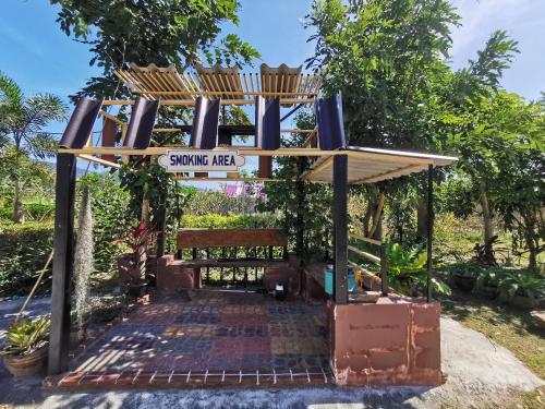 a playground with a sign that reads swinging need at Viman Resort in Chon Buri