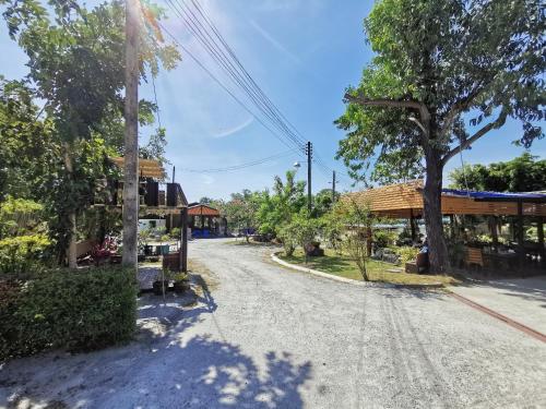 an empty street in a village with a building at Viman Resort in Chon Buri