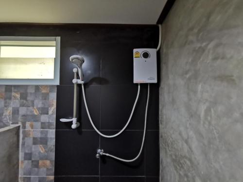 a shower in a bathroom with a camera on the wall at Viman Resort in Chon Buri