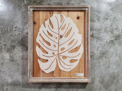a picture of a leaf design on a wooden frame at Viman Resort in Chon Buri