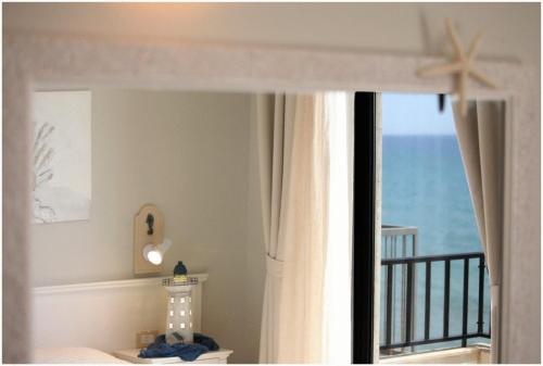 a room with a window with a view of the ocean at Hotel Acquamarina in Donnalucata