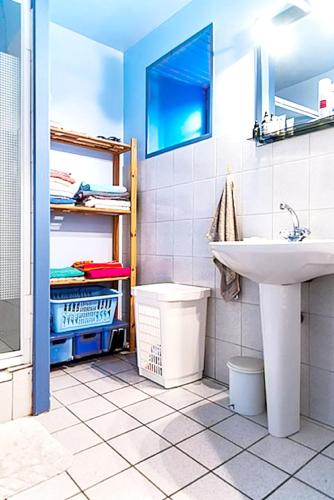 a bathroom with a sink and a toilet and a mirror at Maison confortable à Plehedel avec cheminée in Pléhédel