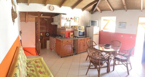 a kitchen and dining room with a table and chairs at Maison de 2 chambres avec jardin clos et wifi a Le Moule a 2 km de la plage in Le Moule