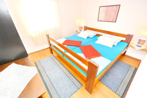 - une chambre avec un lit doté de draps bleus et d'oreillers rouges dans l'établissement 3 bedrooms appartement at Vir 250 m away from the beach with enclosed garden and wifi, à Vir
