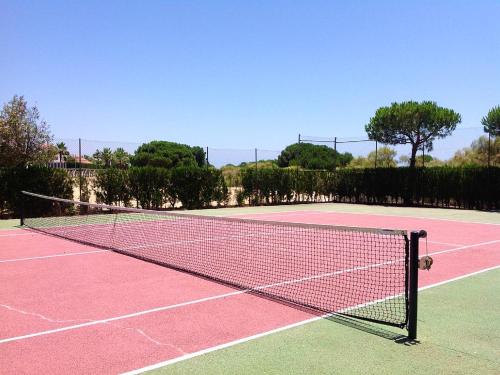 a tennis net on a tennis court at Charming apartment in El Rompido with sea view in El Rompido