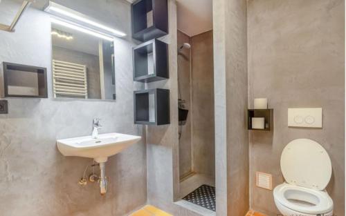 a bathroom with a toilet and a sink at Spacious villa in Florenville with private pool in Florenville