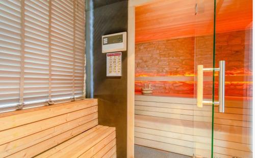 a room with a sauna with a window at Spacious villa in Florenville with private pool in Florenville