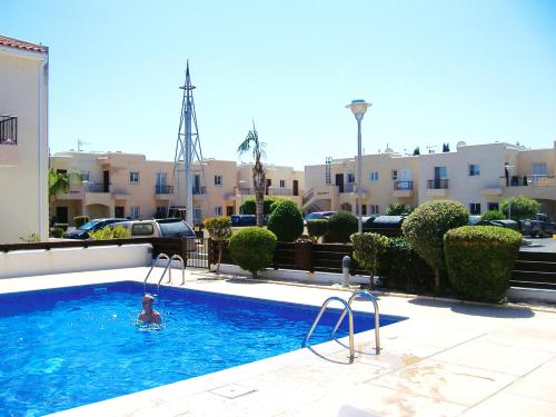 a person in a swimming pool in a apartment at 2 bedrooms appartement with shared pool and wifi at Mandria 1 km away from the beach in Mandria