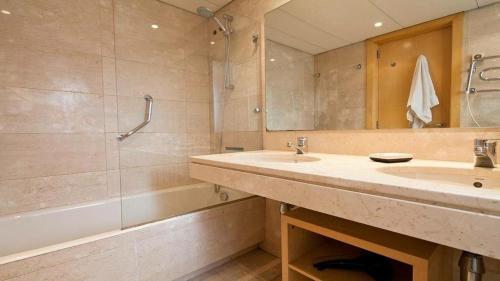 une salle de bain avec un lavabo, une douche et une baignoire dans l'établissement Spacious Duplex in Barcelona with outdoor terrace - 180 m², à Barcelone