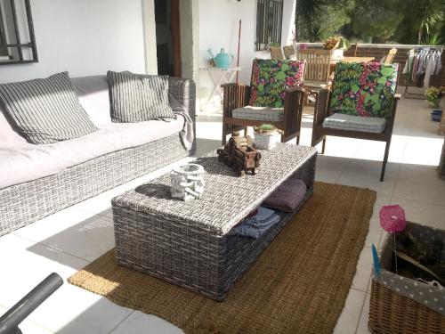 a living room with couches and a table and chairs at Charming villa near Tortosa with private pool in Tortosa