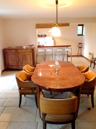 une salle à manger avec une table et des chaises en bois dans l'établissement Appartement spacieux avec vue sur les montagnes à Espalion, à Espalion
