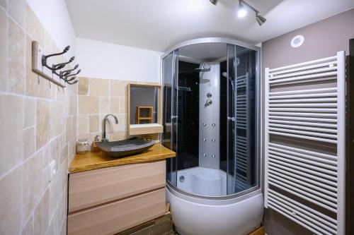 a bathroom with a shower and a sink and a tub at Studio avec wifi a Orcieres a 2 km des pistes in Orcières