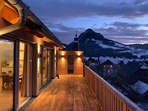 a balcony of a house with a view of a mountain at Die Tauplitz Lodges - Penthouse Grimming D7-1 by AA Holiday Homes in Tauplitz