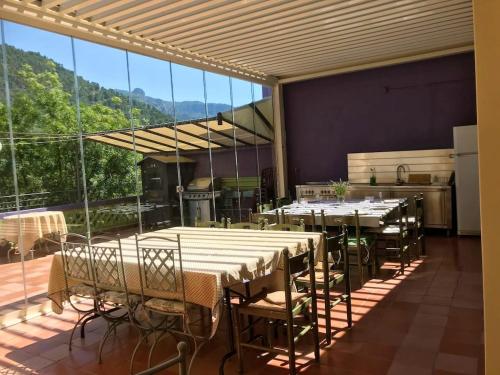 a dining room with tables and chairs on a balcony at 6 bedrooms house with furnished terrace and wifi at Olivetta in Olivetta