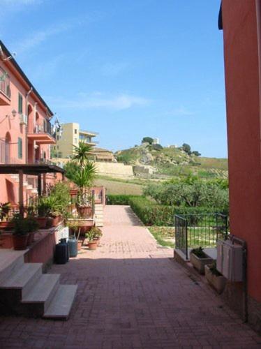 a brick walkway with stairs and potted plants at Welcoming Apartment in Realmonte with Sea View - 53 m² in Realmonte
