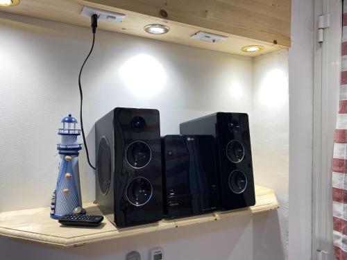 a shelf with two speakers and a lighthouse on it at Welcoming Apartment in Realmonte with Sea View - 53 m² in Realmonte