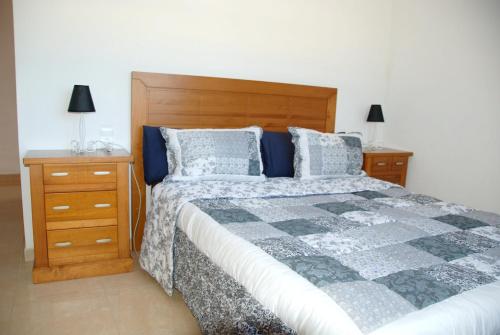una camera da letto con un letto e due comodini di Comfortable House in Les Tres Cales with Private Pool a Les tres Cales