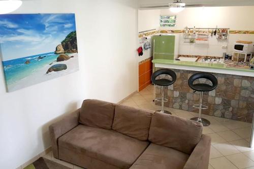 a living room with a couch and a kitchen at Maison d'une chambre a Schoelcher a 20 m de la plage avec terrasse amenagee et wifi in Schœlcher