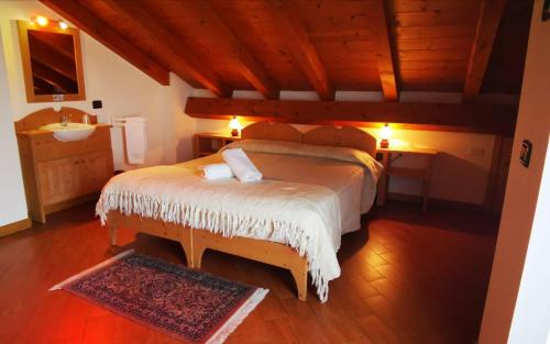 a bedroom with a large bed and a sink at Bed & Breakfast Paradiso in Cesiomaggiore