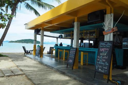 a restaurant on the beach with tables and chairs at Koh Mak Resort in Ko Mak