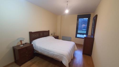 a bedroom with a large bed and a window at Las Nieves de Lillo in Puebla de Lillo