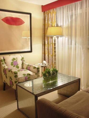 a living room with a coffee table and a chair at The Mandeville Hotel in London