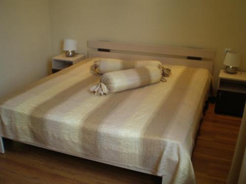 a bedroom with a bed with two pillows on it at Park Hotel Djevana in Gorna Oryakhovitsa