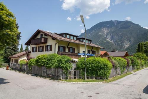 a house with a fence in front of a mountain at Lichtblick in Farchant