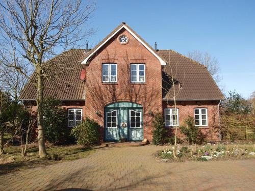 a brick house with a clock on top of it at Ferienhaus Marsch auf Föhr in Borgsum