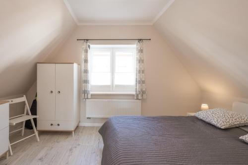 Schlafzimmer mit einem Bett und einem Fenster in der Unterkunft Tine in Husum
