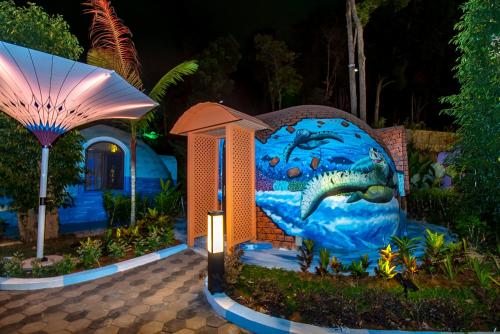 a building with a painting of a fish on it at MyRus Resort Langkawi in Pantai Cenang
