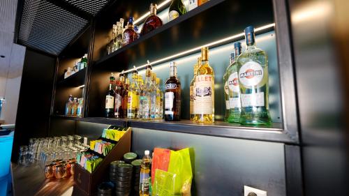 a bar with many bottles of alcohol on a shelf at Laax wellnessHostel3000 in Laax