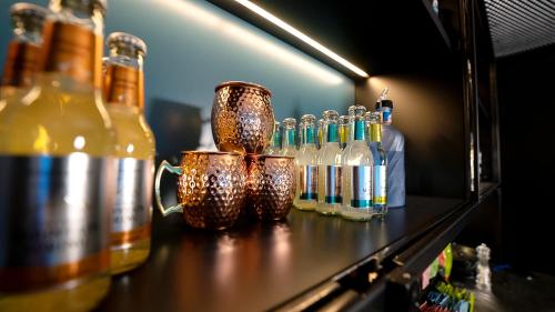 a counter with bottles of alcohol on a shelf at Laax wellnessHostel3000 in Laax