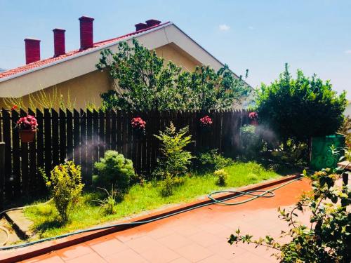 a garden in front of a house with a fence at VNVP Black Amber in Štip