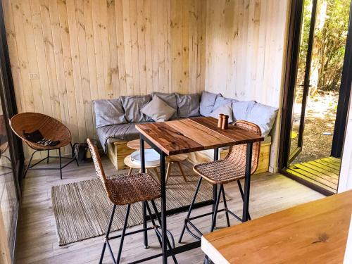 a room with a table and chairs and a couch at OUTSCAPE l Refugios Puerto Fuy, Huilo Huilo in Puerto Fuy