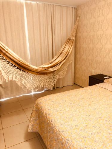 una camera con un letto con un drappeggio e una finestra di Beach Front Apartment near Beach Park a Fortaleza